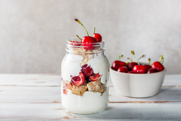 Bitesize shredded wheat with fresh cherry berries in Jar