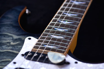Fototapeta na wymiar Electric guitar close up. Black background.