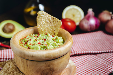 guacamole with nachos next to fresh ingredients