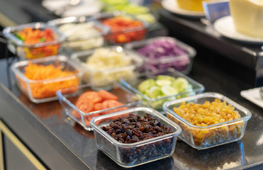 Close up salad bar with various fresh vegetables at market