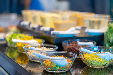 Close up salad bar with various fresh vegetables at market