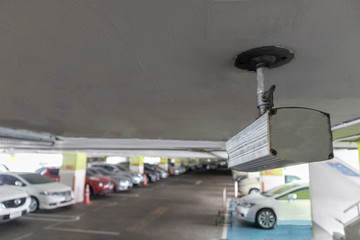 Obraz na płótnie Canvas CCTV security camera in parking lot security cars. Security Concept.