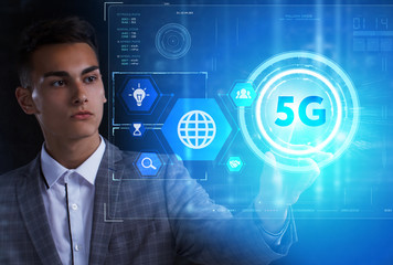 The concept of business, technology, the Internet and the network. A young entrepreneur working on a virtual screen of the future and sees the inscription: 5G