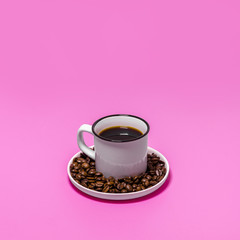Cup of coffee on pink background