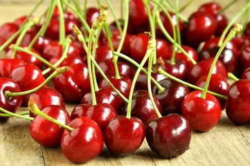 red sweet cherries on wooden background