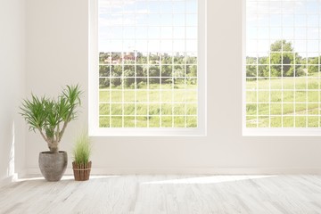 Fototapeta premium Stylish empty room in white color with summer landscape in window. Scandinavian interior design. 3D illustration