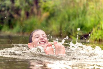 boy swims in the river