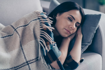 Close up photo beautiful she her lady  fell asleep after dinner hands arms under head eyes closed dreaming covered blanket wear checkered plaid shirt lying comfy divan flat house living room indoors