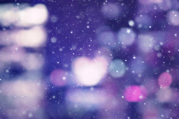 city lights snow glow background blurred / cityscape blurred bokeh, snowy weather seasonal background winter December
