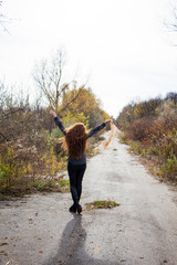 young redhead woman with scarf in autumn park 