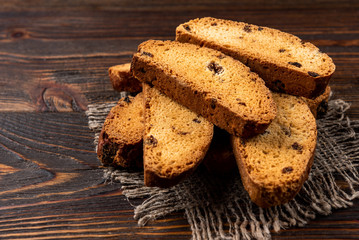 Crispy rusk on dark wooden background.