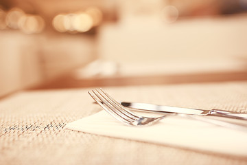 serving in the restaurant, fork and knife / interior view of the restaurant with a table served knife and fork on the table in a cafe