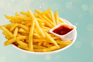 Fresh fried french fries with ketchup on wooden background
