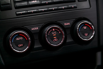 Fototapeta premium Сlose-up of the car black interior: adjustment of the blower, air conditioner and other buttons.