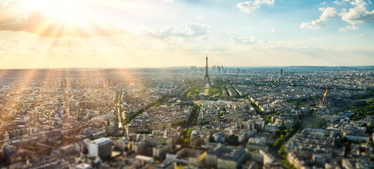 Paris street with view on the famous paris eiffel tower on a sunny day with some sunshine