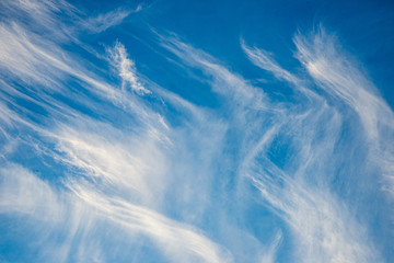 blue sky with clouds and plane trails