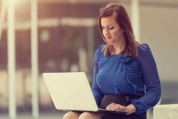 Beauty woman sitting and using a laptop