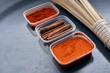 Spices in plastic containers with bamboo brush