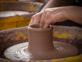 hands of potter on potters wheel