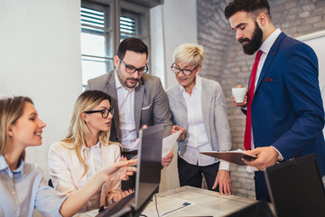 Group of business people working in office and discussing new ideas
