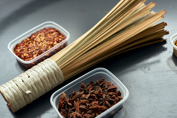 Spices in plastic containers with bamboo brush