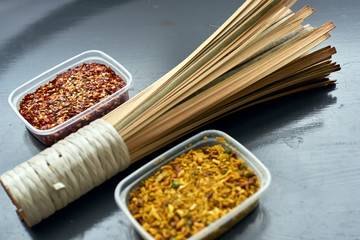 Spices in plastic containers with bamboo brush