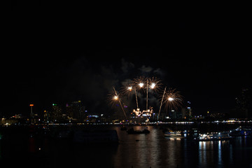 coconut long tail fireworks on beach and reflection color on water surface