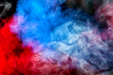 Fototapeta na wymiar Dense multicolored smoke of red, purple and pink colors on a black isolated background. Background of smoke