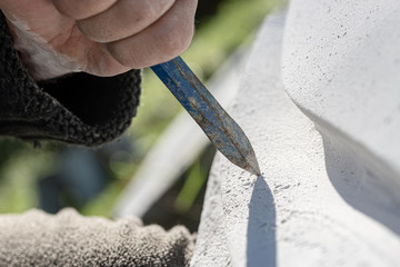 Closeup view of chisel as sculptor works
