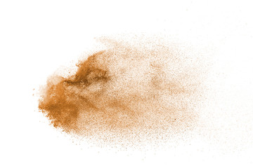 Fototapeta na wymiar Explosion of brown powder on white background.
