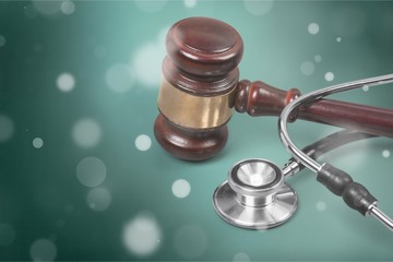 Gavel and stethoscope  on background, symbol photo for bungling and medical error