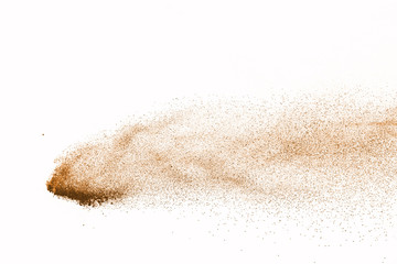 Fototapeta na wymiar Explosion of brown powder on white background.