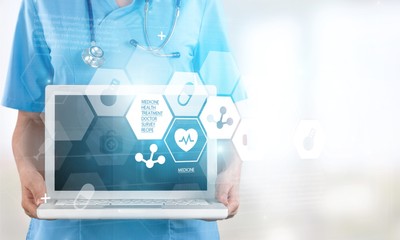 Close-up Doctor at hospital working with laptop