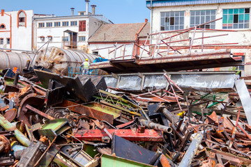 Pile rusted cut parts of obsolete equipment in industrial complex