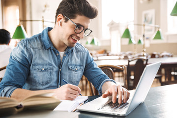 Smiling male student studying