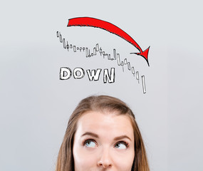 Market down trend chart with young woman looking upwards