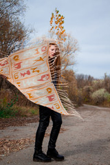 Young redhead woman with scarf in autumn park 