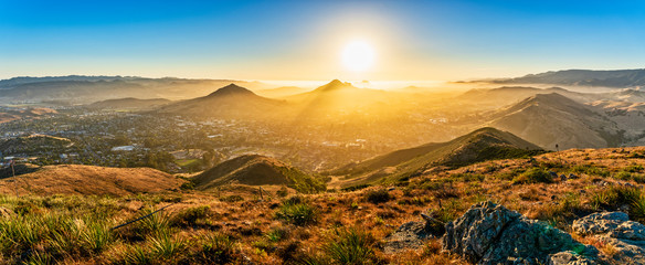 Sunset over Mountains and City