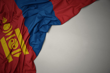 waving national flag of mongolia on a gray background.