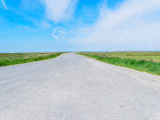 Fototapeta premium Long road to the beach at low tide in Cherrueix, France