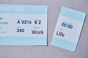 Work life balance choice concept. Boarding pass cut into two parts with inscriptions