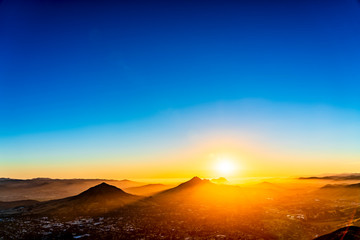 Sunset over City, Mountain Peaks