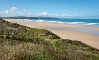 Fototapeta na wymiar Surf on a sandy beach in Cornwall England