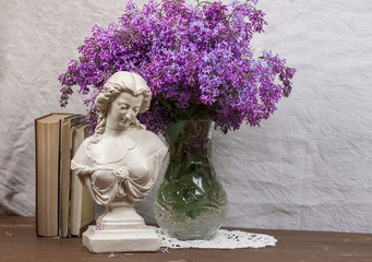 A stillife with gipsum bust and flowers