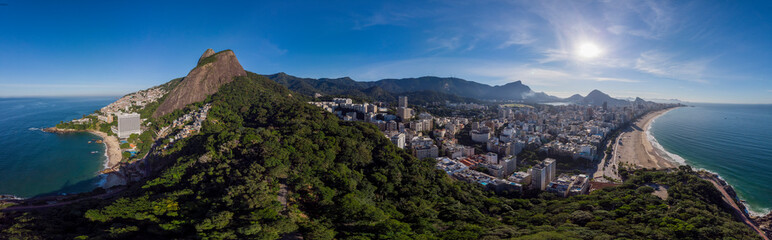 Sunrise 360 degree full panoramic aerial view of Two Brothers mountain and Leblon beach and neighbourhood in Rio de Janeiro in the foreground and the wider cityscape in the background