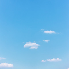 Light cyan blue sky with white clouds