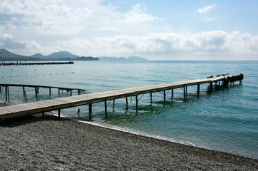 Seascape with pier and hills