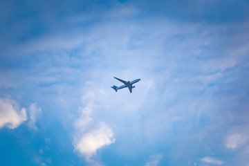 Fototapeta na wymiar airplane flying in the sky with clouds