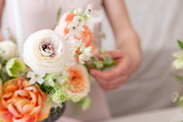 Woman hands touching  a bouquet of flowers.