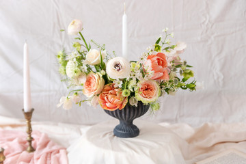 Still life with a beautiful bouquet of flowers and candles